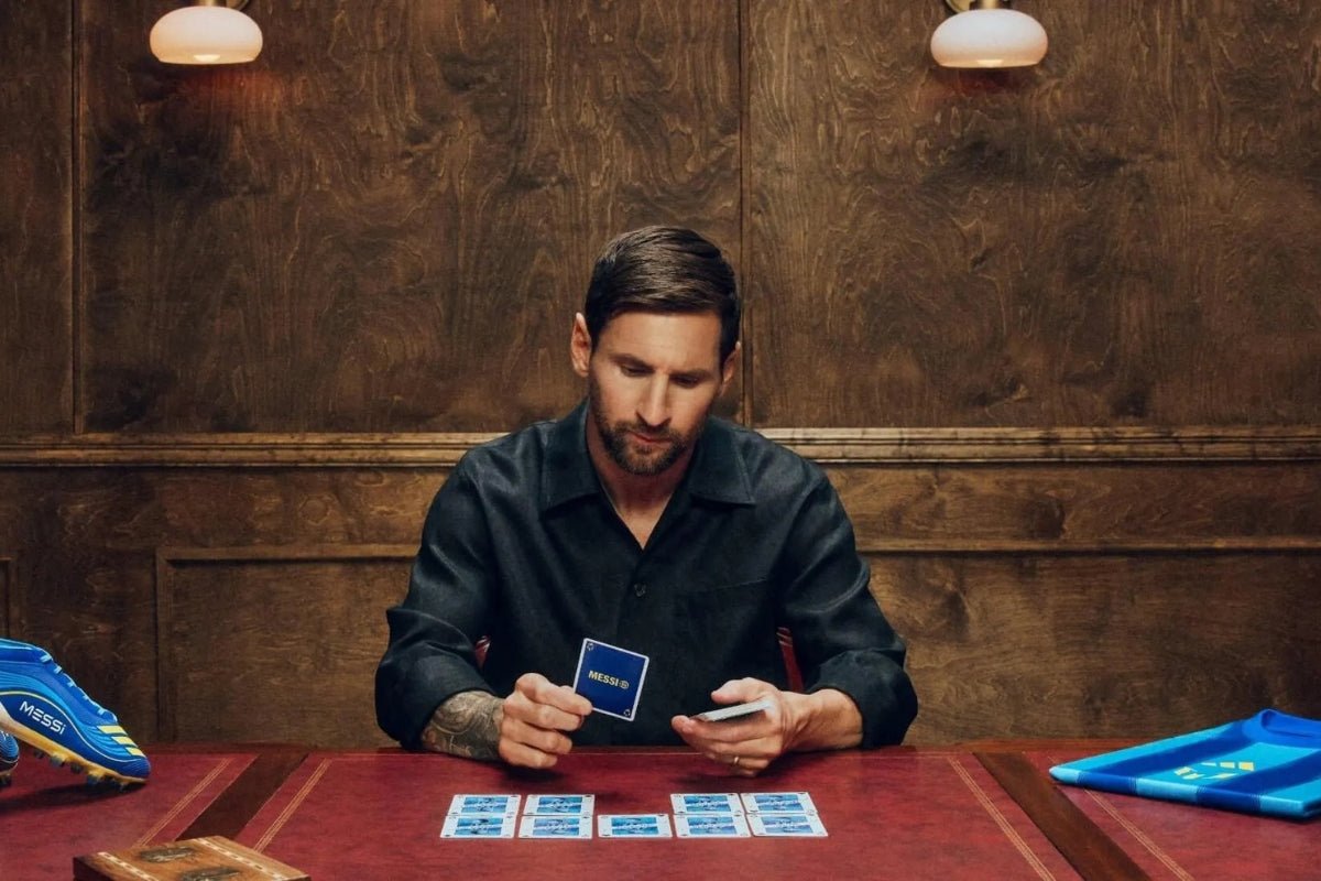 Messi playing cards in a room with soccer cleats on the table